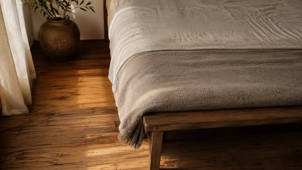 Serene bedroom corner with a soft throw folded at the foot of the bed