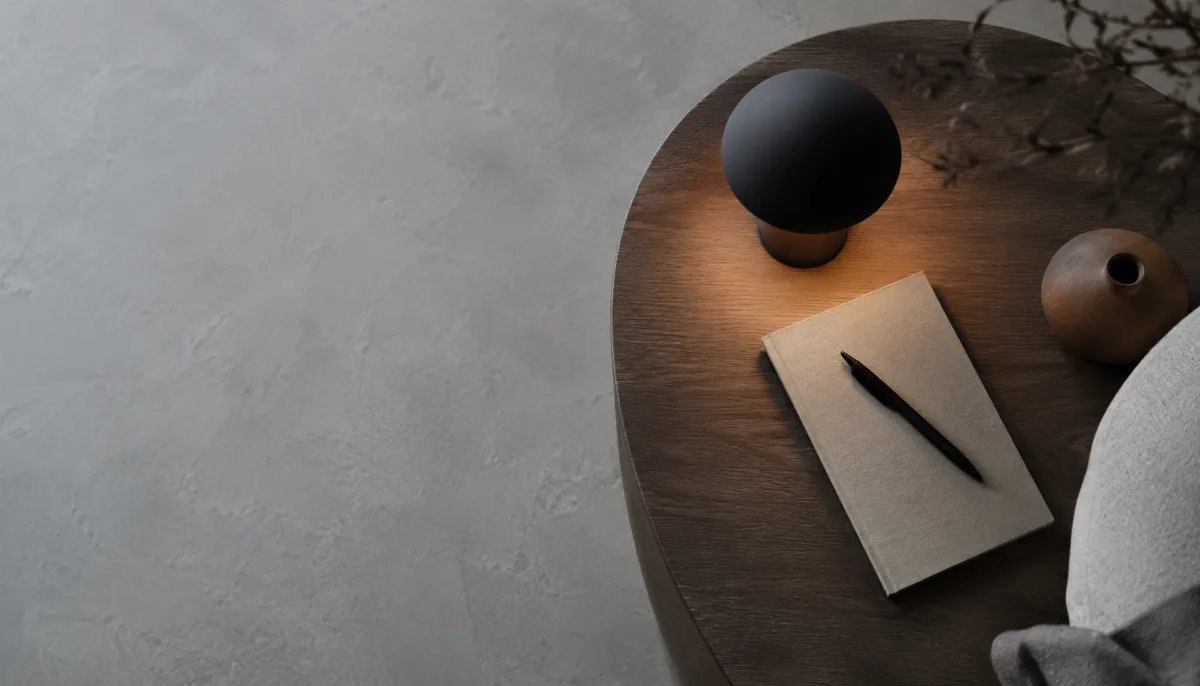 Small table lamp casting a soft pool of light on a side table